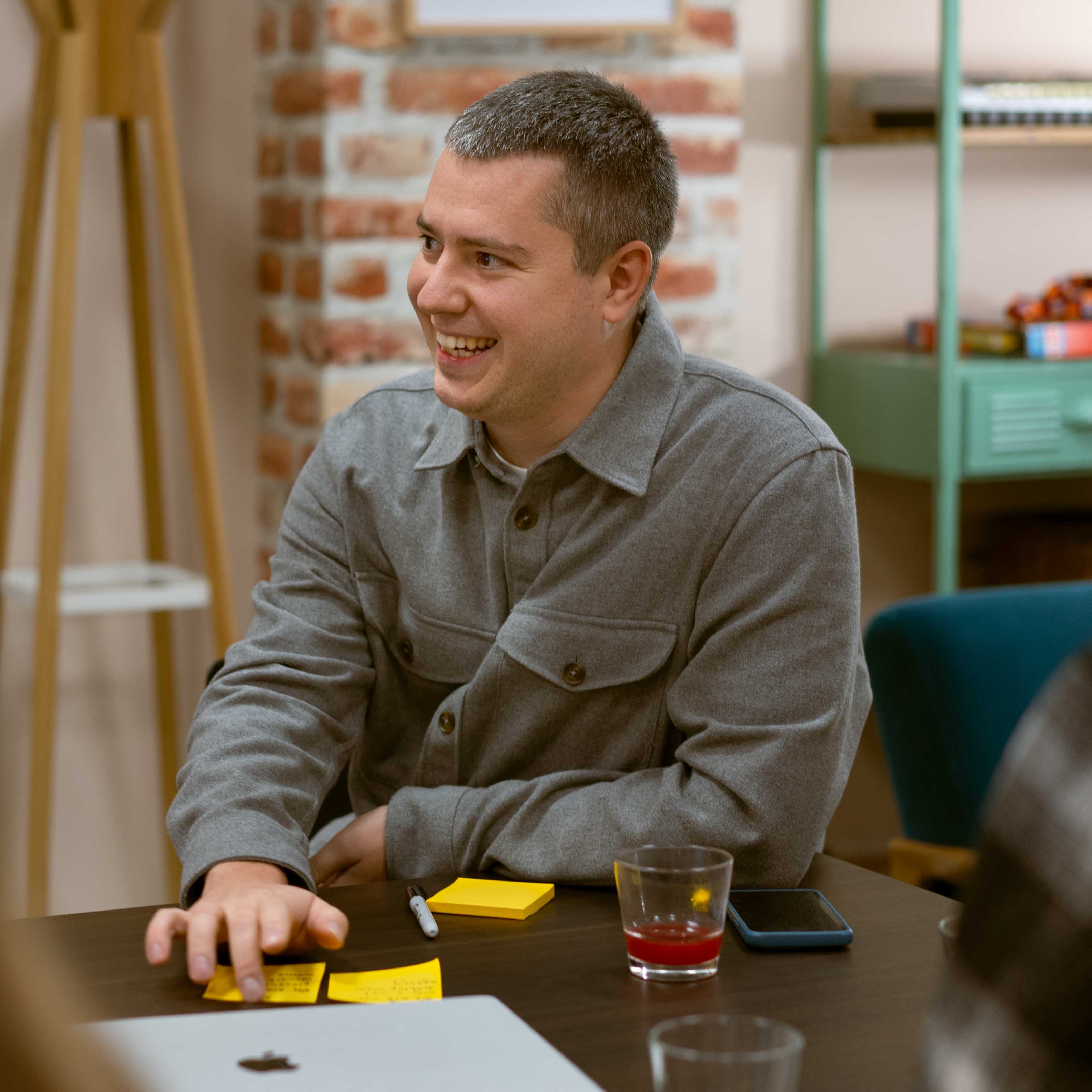 white smiling man sitting in office 