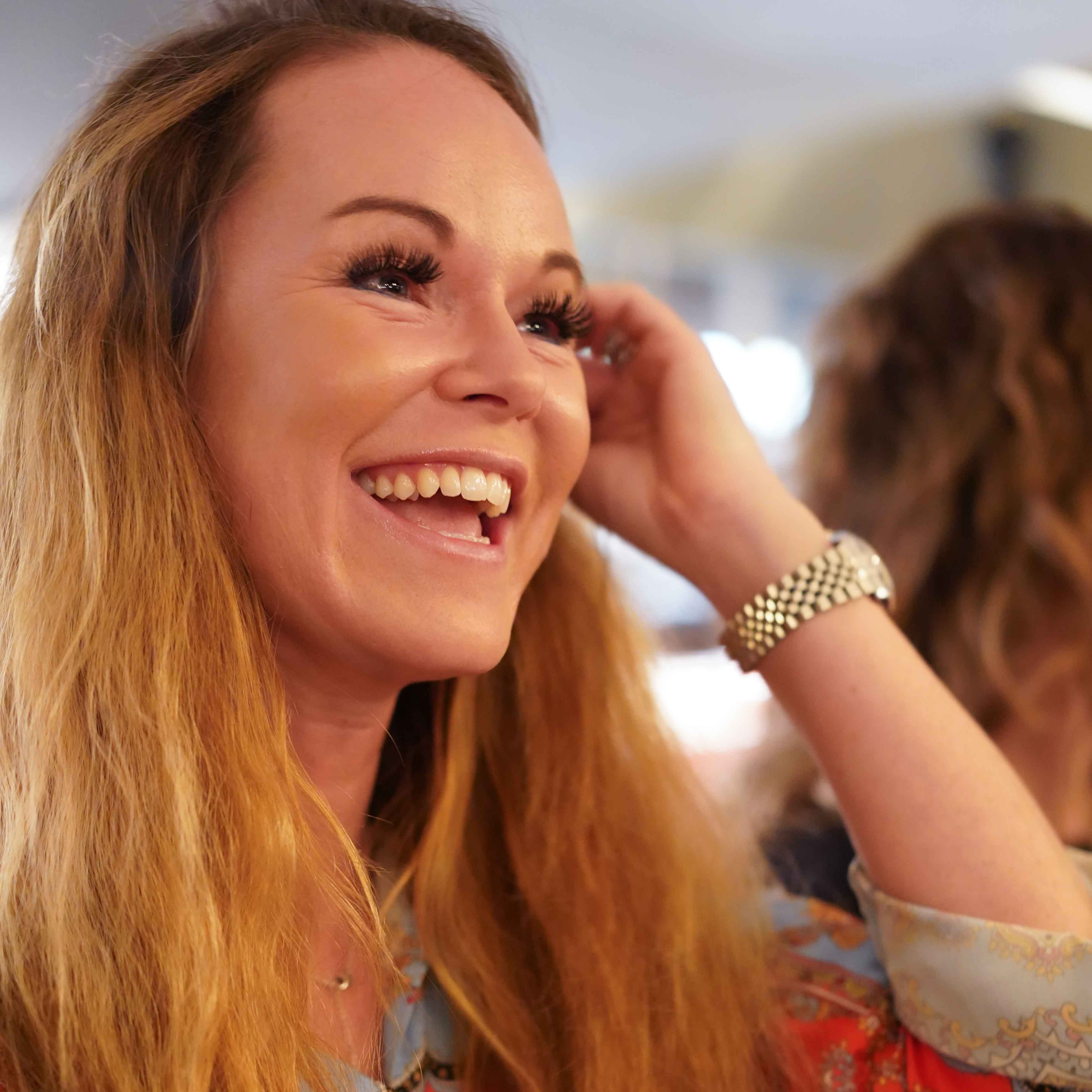 White woman with long blond hair smiling
