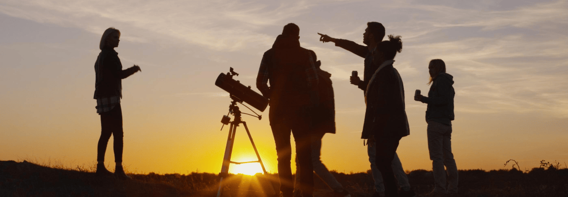 Group of people around telescope