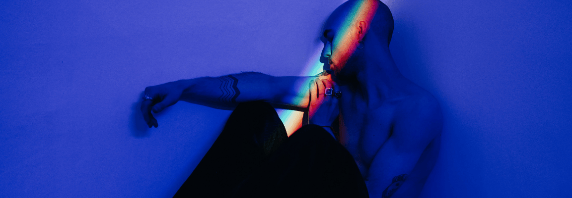 Mental health tools for healthcare providers Man sitting on bed in blue light