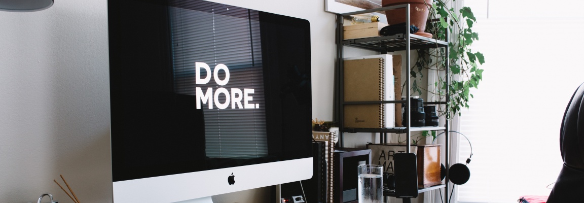Do more with the right digital partner for your organization. Here's how to find them. Computer screen on a desk with the words 'DO MORE' in large white letters on a black background
