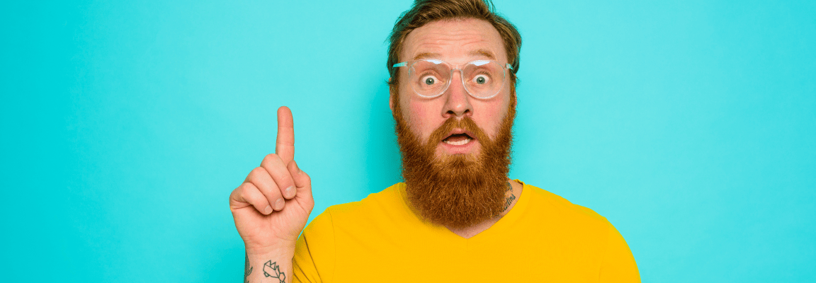 Upgrading from Drupal 7 to Drupal 9 or 10 doesn't have to be difficult A white man with a beard in a yellow t-shirt and glasses looks like he has an idea