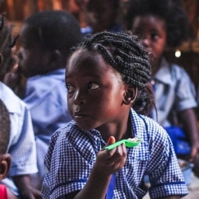 Child eating lunch at a Concern-supported school